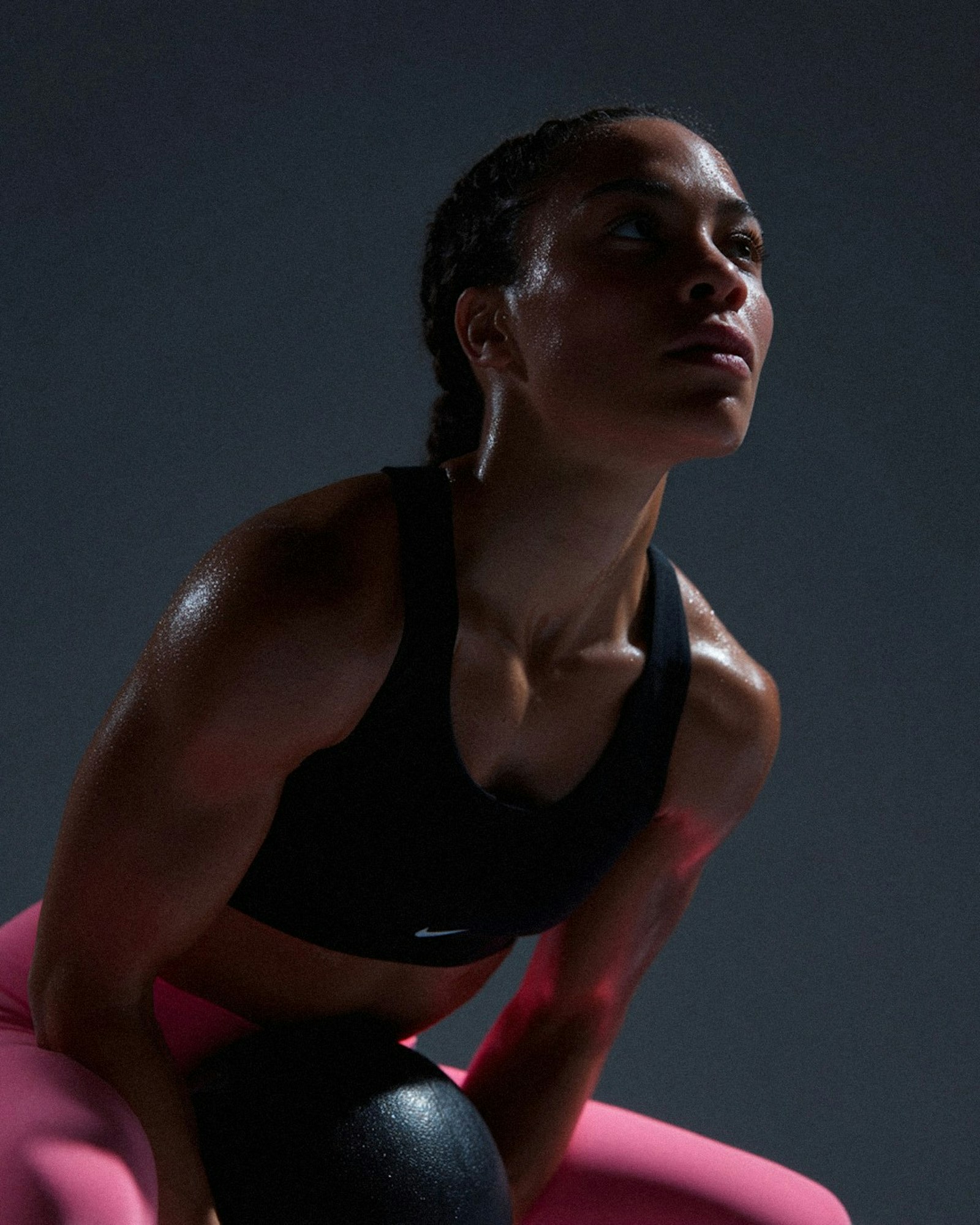 Athlete mid-workout holding a medicine ball, focused and sweating